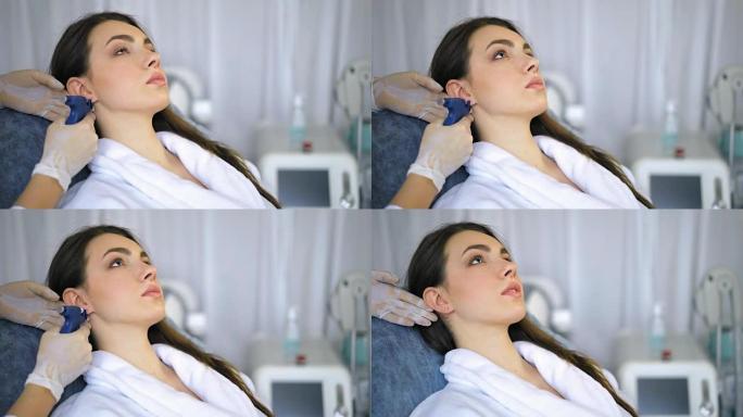 美容师在美容院做耳洞手术
