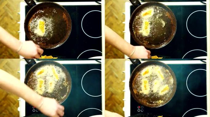 块。在煎锅里煎炸的过程。浸入沸腾的油中。