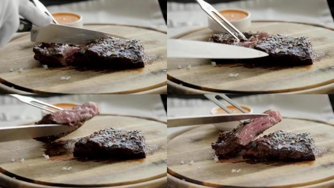 餐馆里的那个人用刀切了大理石牛肉牛排，烤了。在木板上服务。在厨房烹饪牛排。新鲜、美味、辛辣、多汁的肉