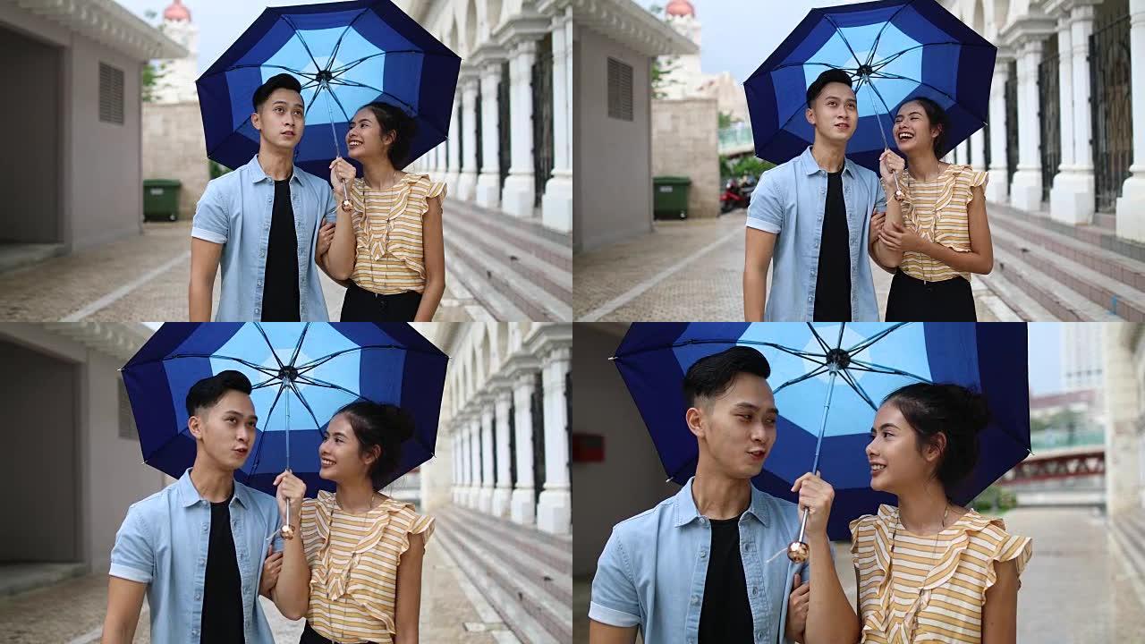 浪漫情侣在伞下散步