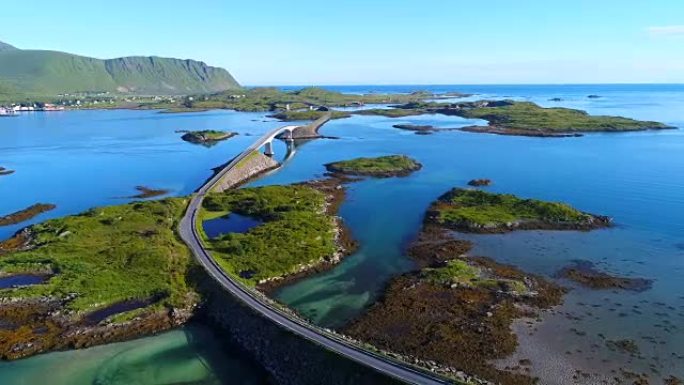 连接小岛的公路和桥梁的4k航拍画面慢慢揭示了通往挪威罗弗滕群岛村庄的桥梁。