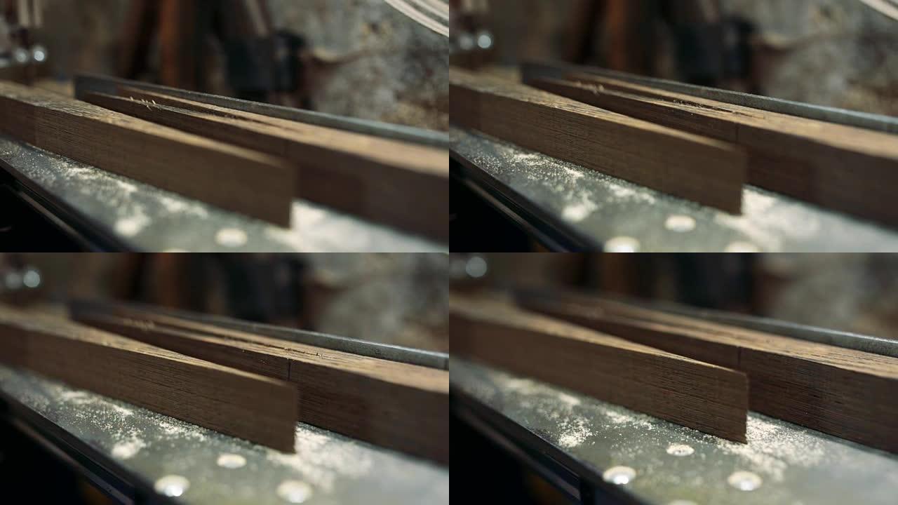 Luthier forms a billiard cue running on a band saw