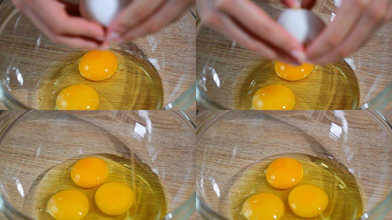 女孩在碗里打碎鸡蛋