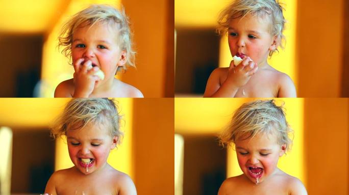 幼儿在镜头前咀嚼和咬梨果的肖像。蹒跚学步的婴儿咀嚼和吐痰健康食品