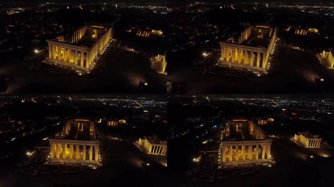 雅典历史中心标志性的古代雅典卫城山和帕台农神庙的空中夜间视频