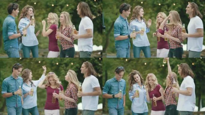 派对。快乐的朋友在户外跳舞和喝酒。