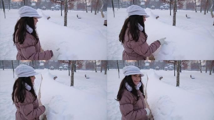 十几岁的女孩在雪地里画心形