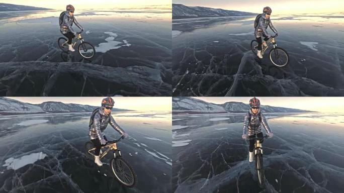 女人在冰上骑自行车。这个女孩穿着银色羽绒服，骑自行车背包和头盔。冰冻的贝加尔湖的冰。自行车上的轮胎上