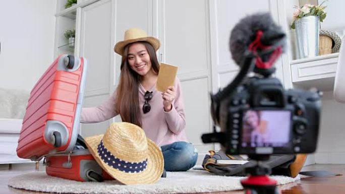 亚洲年轻女性博客作者录制vlog视频，假期准备在家旅行。社交媒体概念上的在线影响者