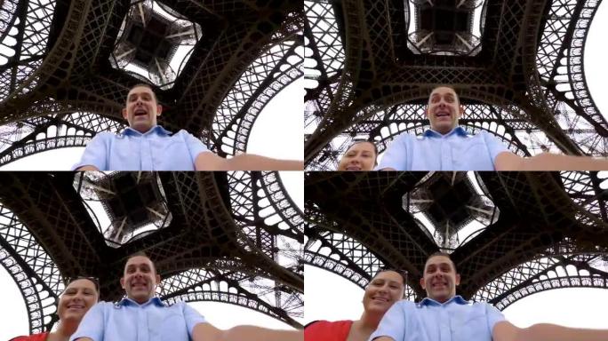 快乐的男人和女人在4k慢动作的巴黎埃菲尔铁塔下旋转和玩乐