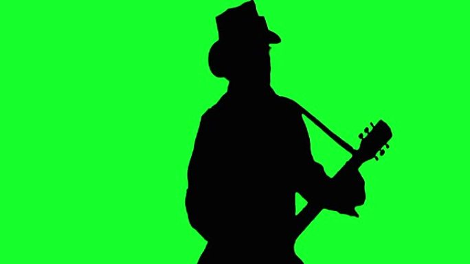 帽子上的酷摇滚吉他手在绿色屏幕上弹奏原声吉他。