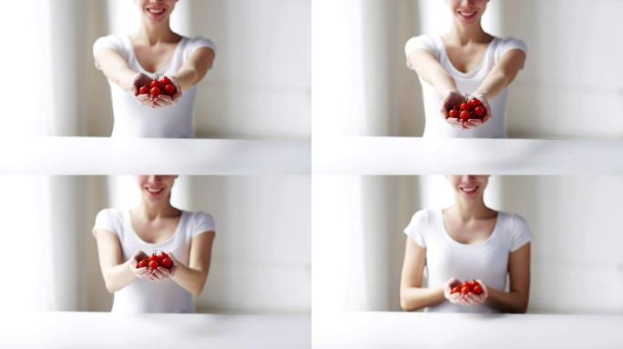 展示樱桃番茄的年轻女子的特写镜头