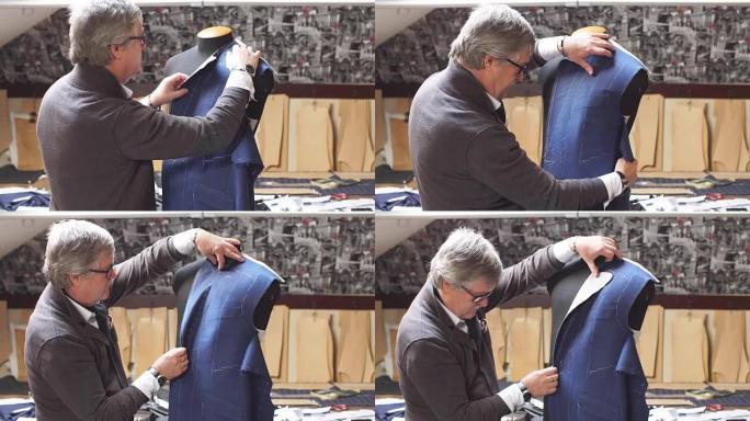 专业成熟的裁缝在他的工作室里使用裁缝假人在他的新古典西装上工作