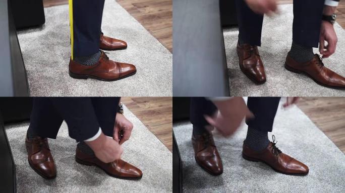 男人穿上棕色皮鞋，系鞋带