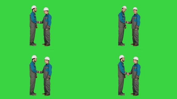 两名建筑商，建筑师在绿色屏幕上握手，色度键