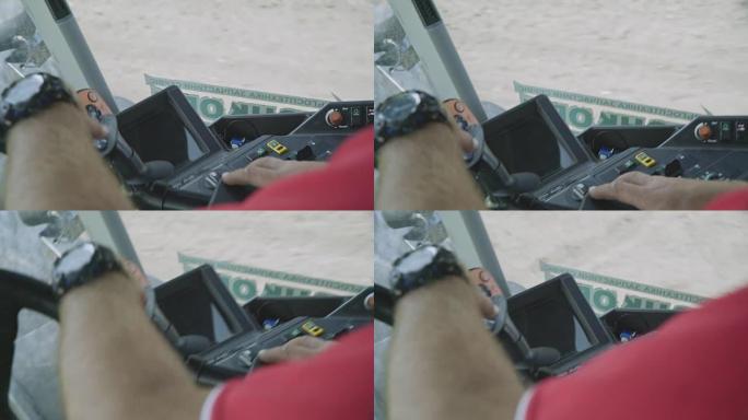 方向盘拖拉机上的男性手司机。拖拉机驾驶