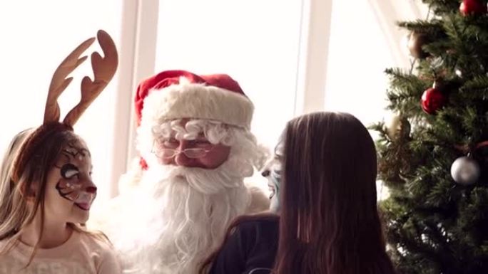 Santa and two young girls with painted face