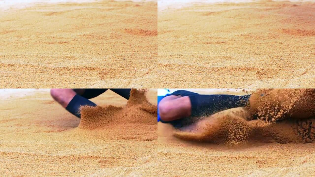 跳远运动员降落在沙坑中