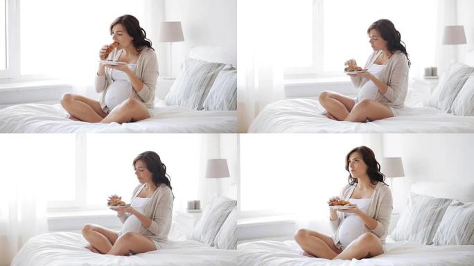 孕妇在家床上吃羊角面包