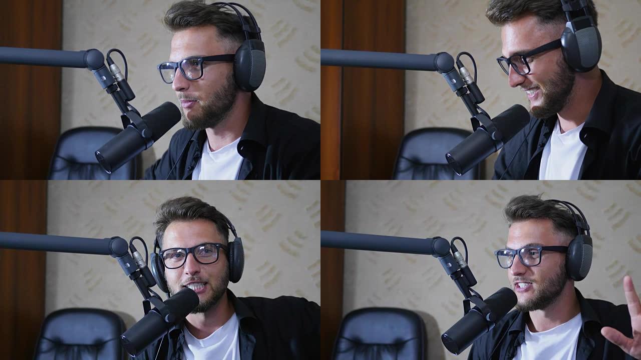 戴着眼镜和耳机的男人广播主持人在演播室对迈克说