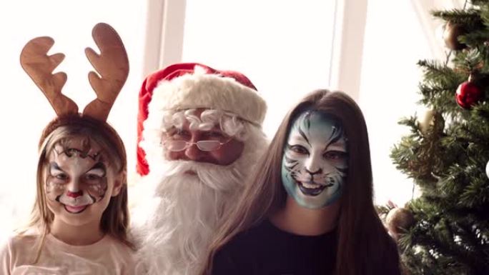 Santa and two young girls with painted face
