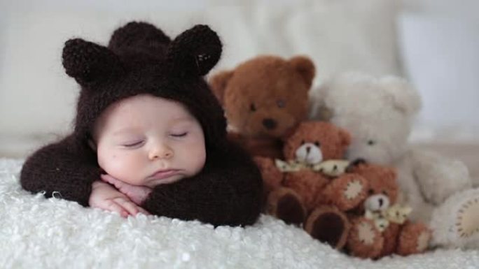 Sweet little baby boy, dressed in handmade knitted