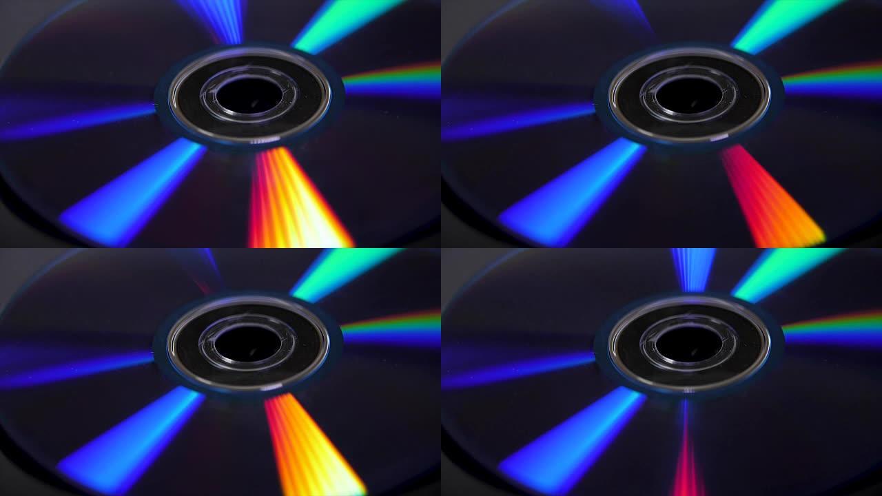 光盘隔离在黑色背景上。光盘上彩色彩虹反射的抽象宏观特写。丰富多彩的抽象背景。CD上的彩虹