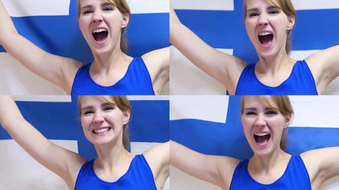 芬兰年轻女子在慢动作中举着芬兰国旗庆祝