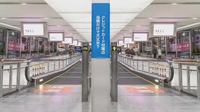 TL: 在日本名古屋机场的自动扶梯上行走的乘客