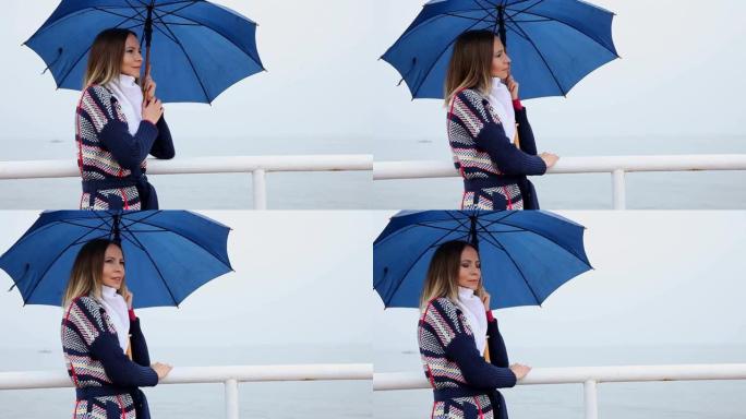 海上码头上带伞的女人。带电动滑块的高清