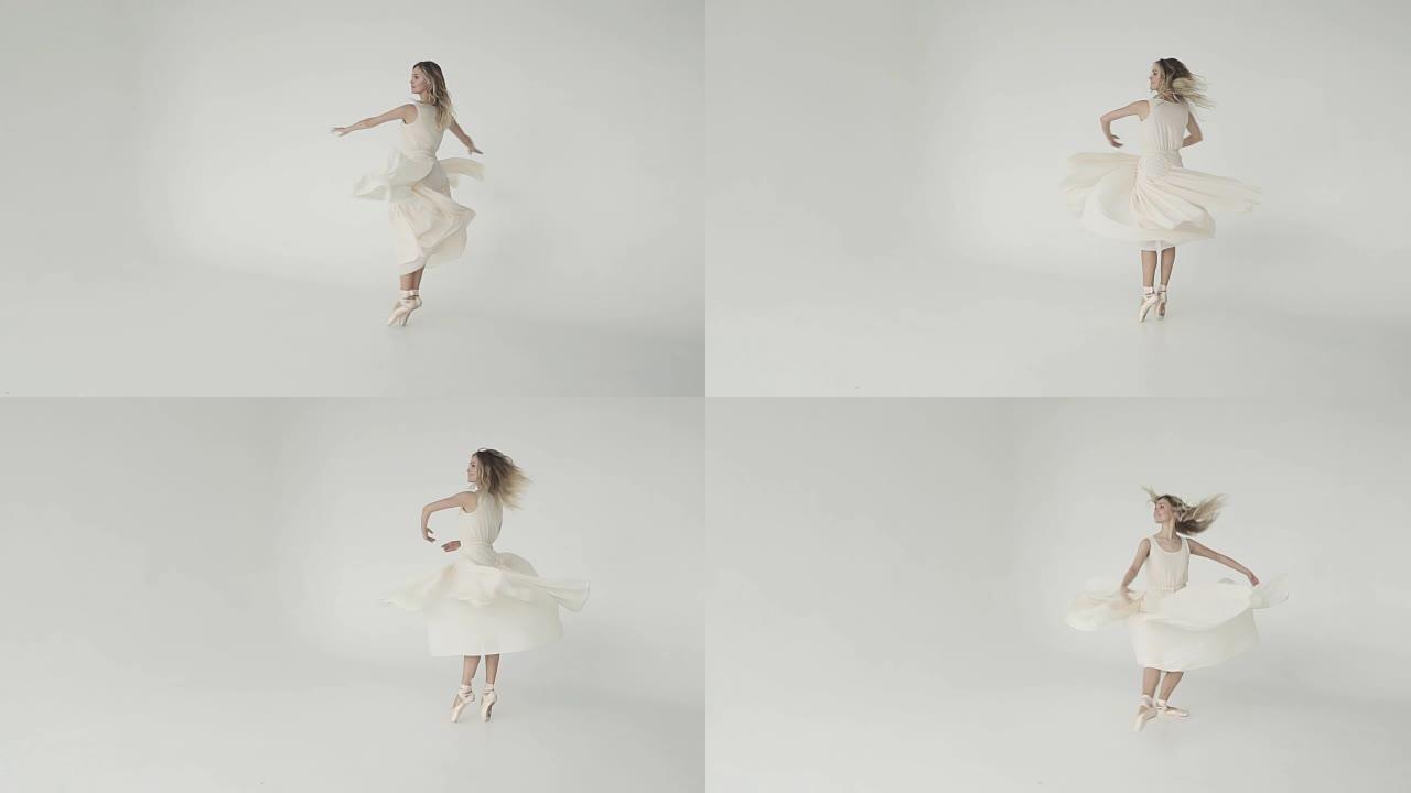 美丽、清新和青春的概念。芭蕾舞女演员穿着白色背景上的轻盈连衣裙旋转。慢动作
