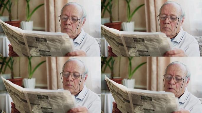 老人坐在椅子上看报纸