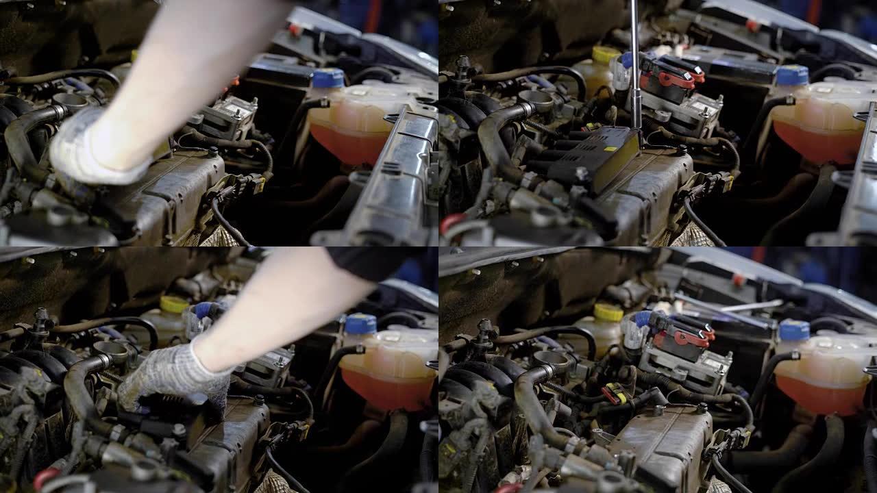 汽车修理厂的工人正在使用扳手将小能量的螺栓拧入汽车内部
