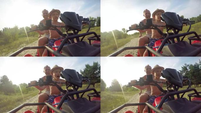 在一个阳光明媚温暖的日子里，爸爸和儿子在地形上开着一辆沙滩车的4K视频