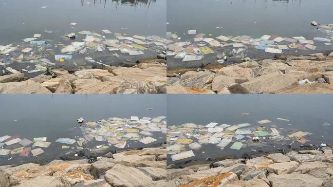 环境污染。河或湖中的塑料瓶、袋子、垃圾。漂浮在水中的垃圾和污染。沿着受污染的海岸运动。特写
