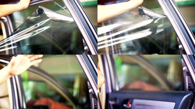 安装车窗色调，双手取下旧车窗薄膜。