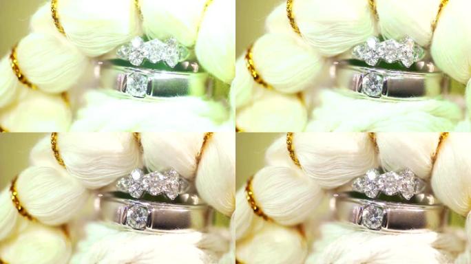 白色纤维背景下结婚戒指的宏观拍摄。