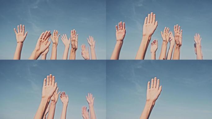 在蓝天的背景下举起双手。投票、民主或志愿的概念