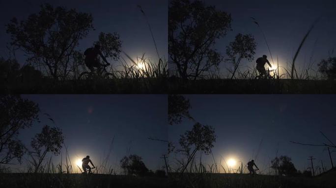 一个年轻人在日落时积极地花时间骑自行车
