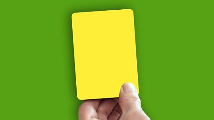手在绿屏上显示黄牌