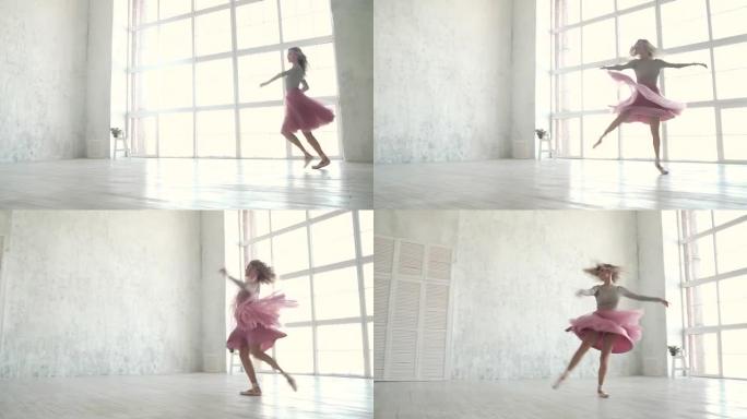 芭蕾舞演员穿着芭蕾舞短裙和脚尖鞋旋转并跳高。年轻的芭蕾舞演员在跳舞。慢动作