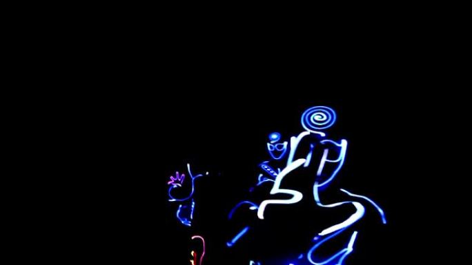 People dancing in costumes of LEDs
