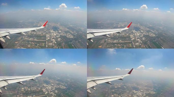 飞机窗户视图在地球景观和云上方飞行