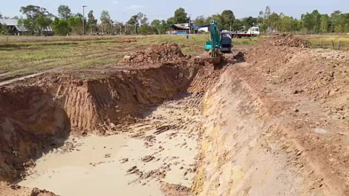 Backhoe dug a pond to store water for use during t