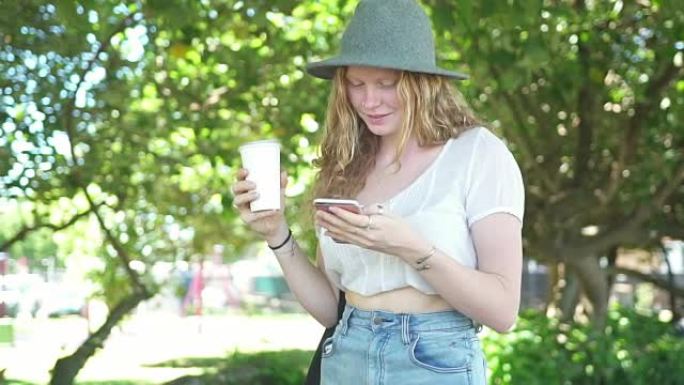 Woman walking in the park and using smart phone