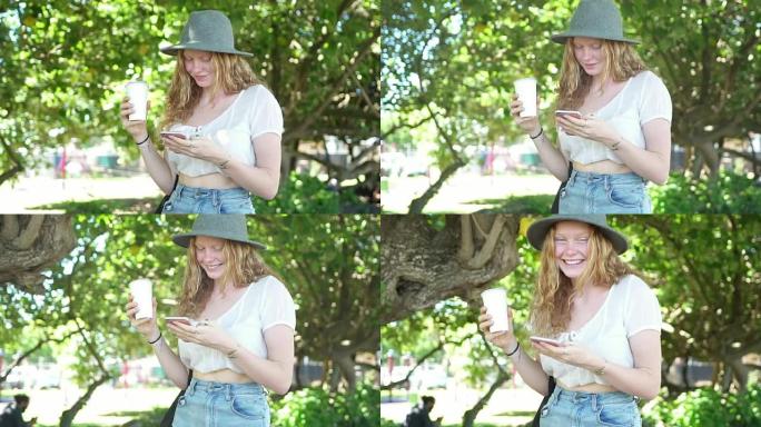 Woman walking in the park and using smart phone