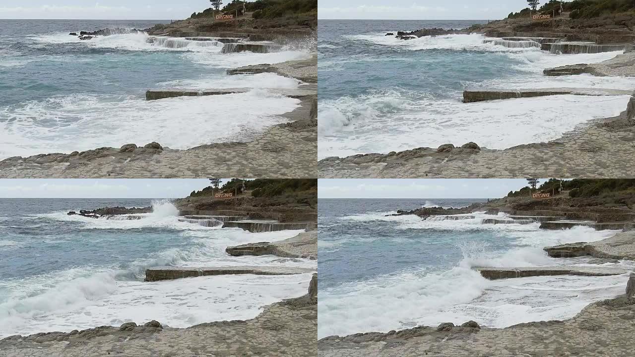 海浪在石墩上破裂。慢动作