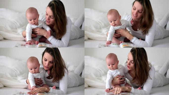 Young mom reading a book to her baby boy, mother r