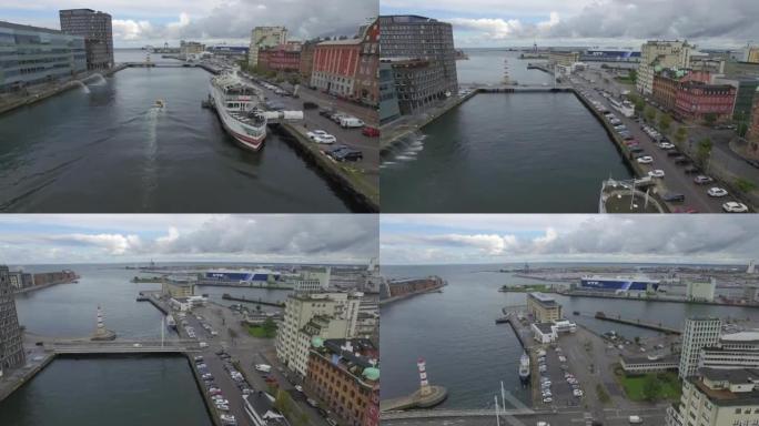 瑞典马尔默市运河的鸟瞰图。无人机在船，港口和大船的背景下飞越运河