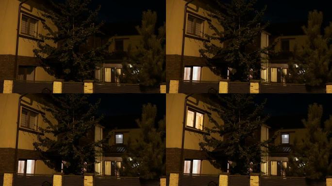住宅小区的松树智能房屋当主人晚上回家时打开灯